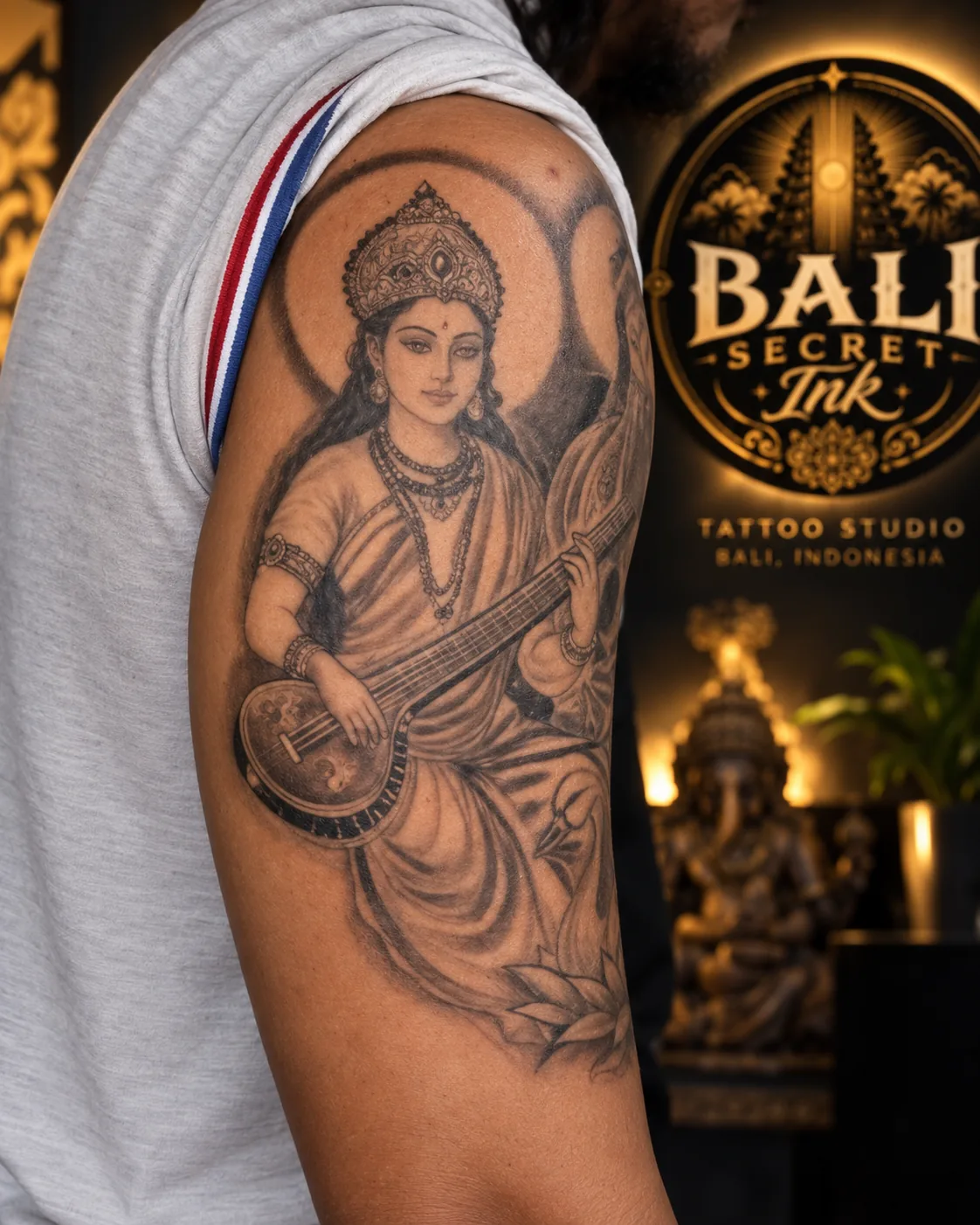 Photograph of a detailed black-and-grey tattoo covering a client's upper arm